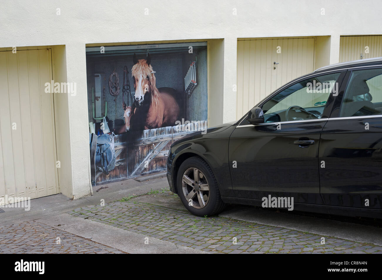 Horses in stable painted onto a garage door Stock Photo