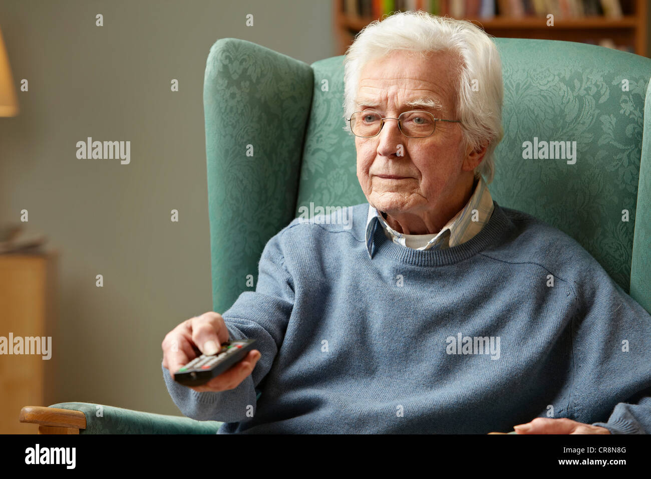 Senior man using remote control Stock Photo