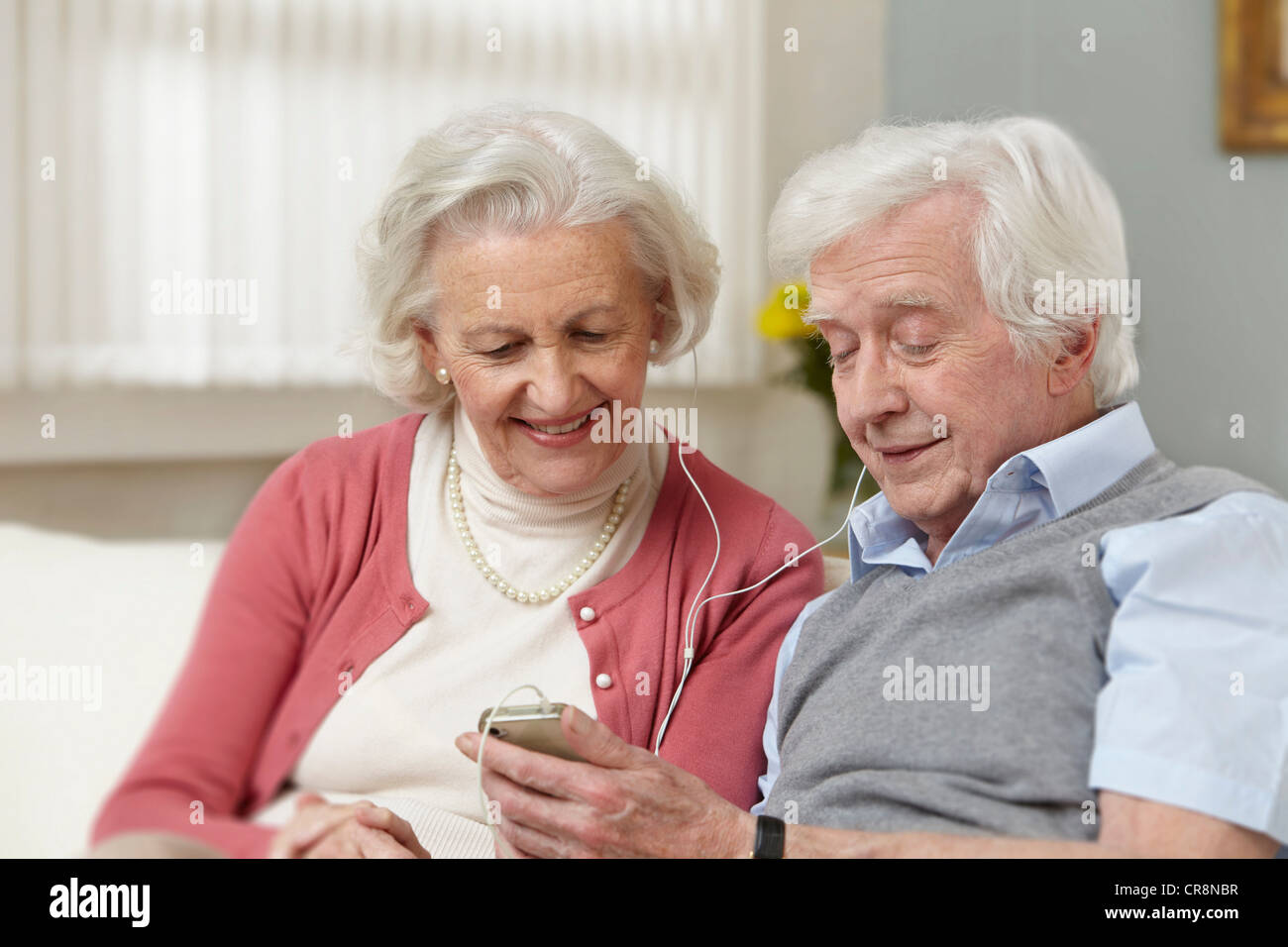 Senior couple listening to mp3 player Stock Photo