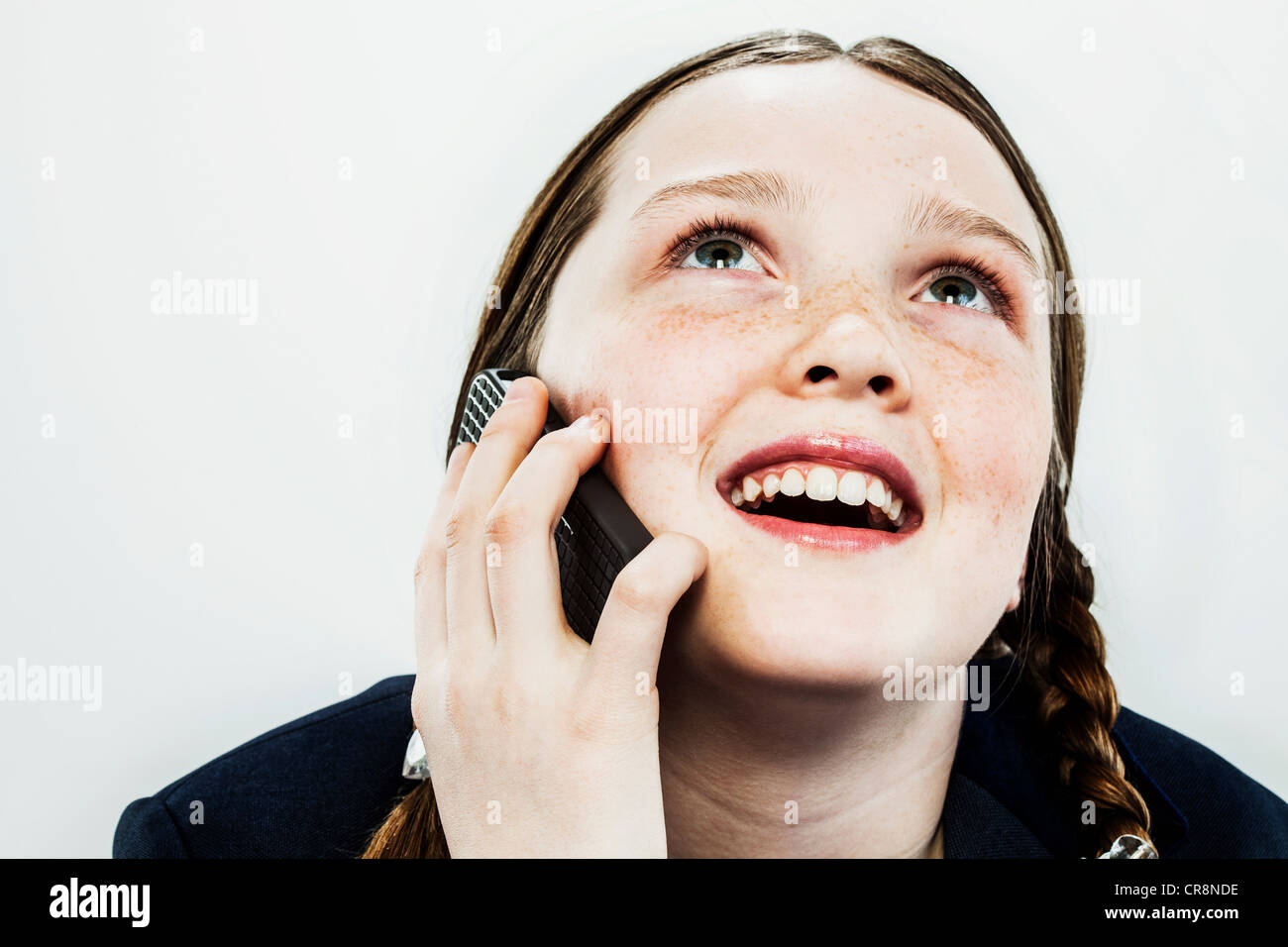 Girl on cell phone, looking up Stock Photo