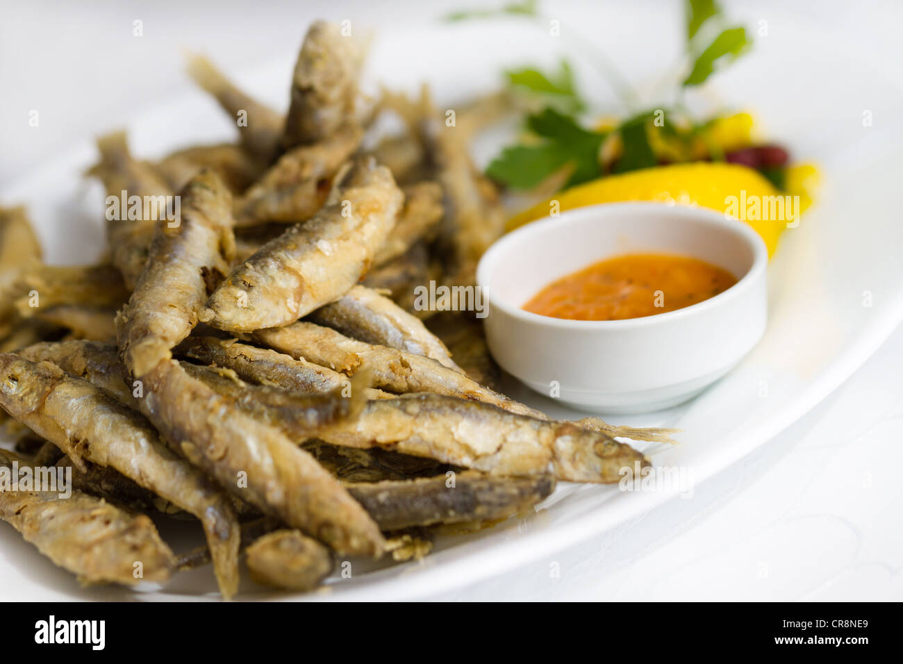 Fried fresh sprat fish with souce. Good seafood Stock Photo Alamy