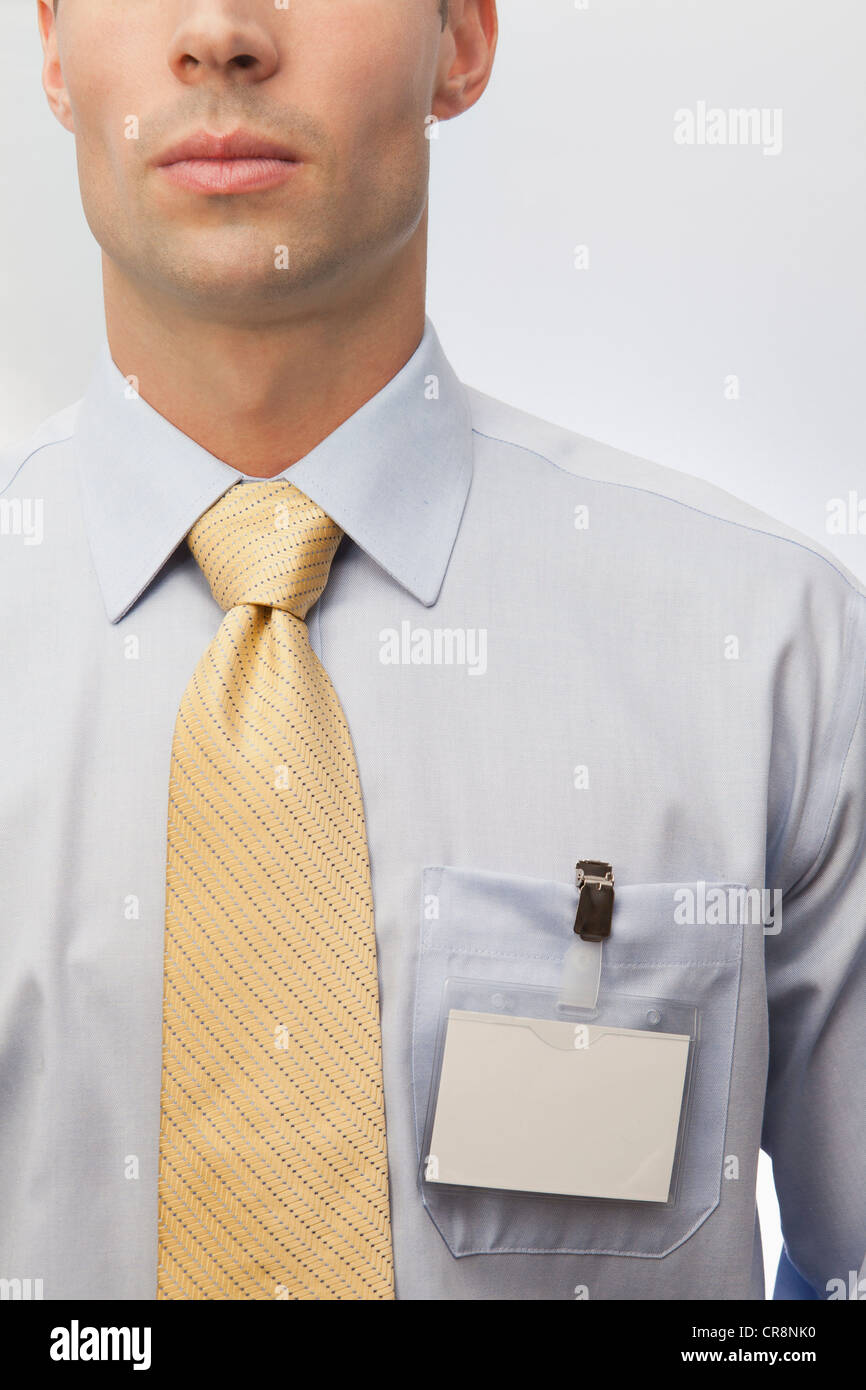 Young man wearing tie and name badge Stock Photo Alamy