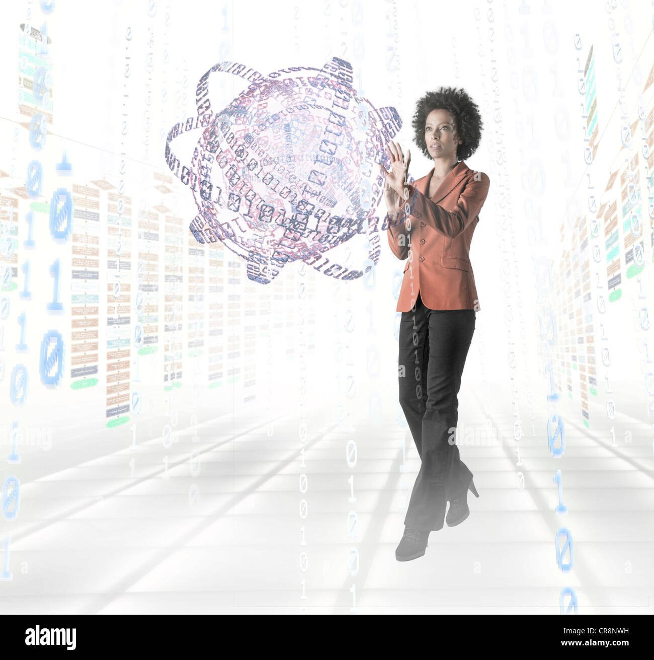 Businesswoman standing amidst digital objects Stock Photo