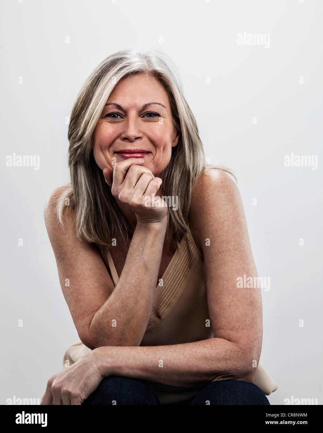 Mature woman with hand on chin Stock Photo