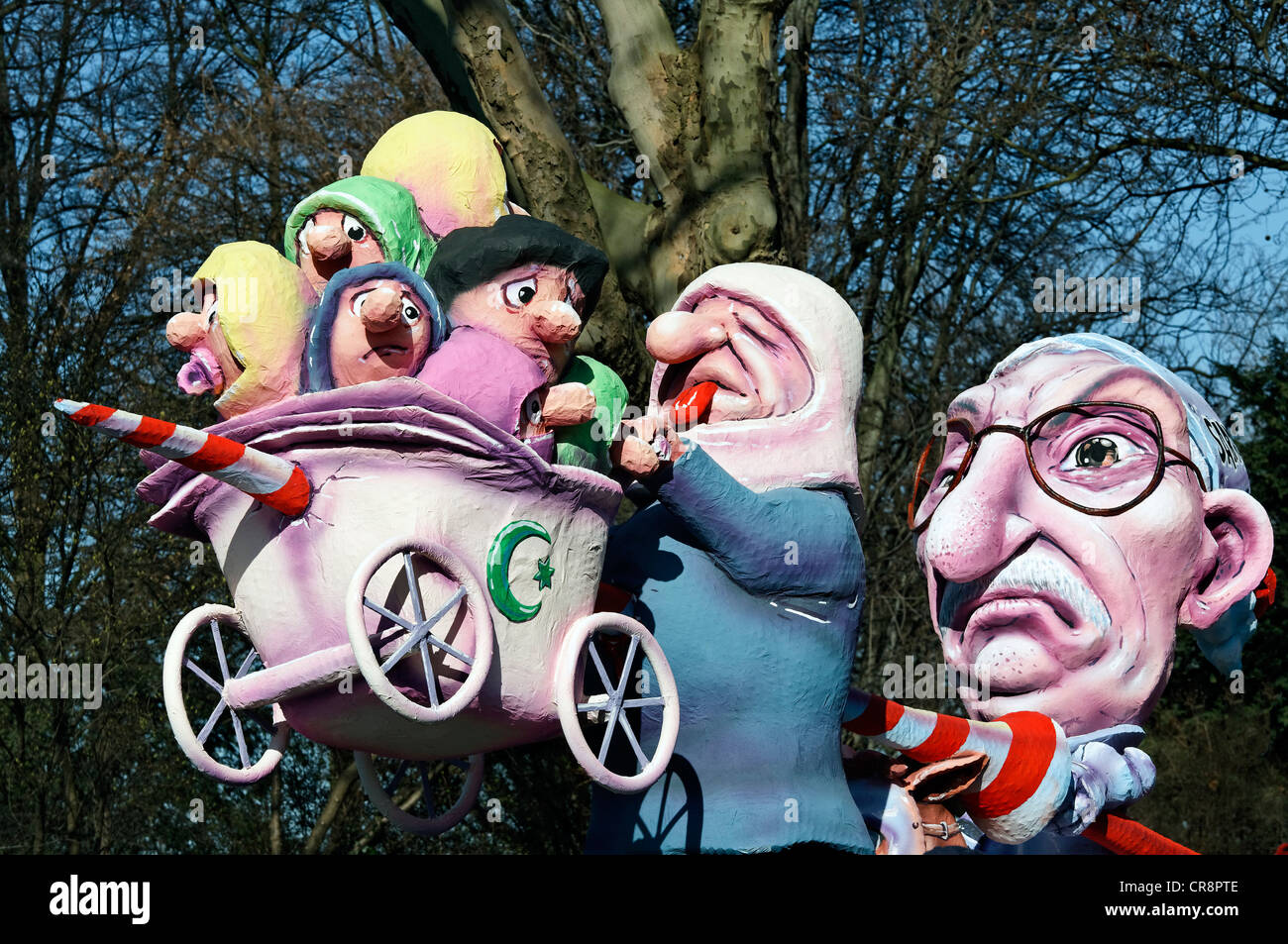 Thilo Sarrazin, impaling Turkish migrants, paper-mache figures, satirical themed parade float at the Rosenmontagszug Carnival Stock Photo