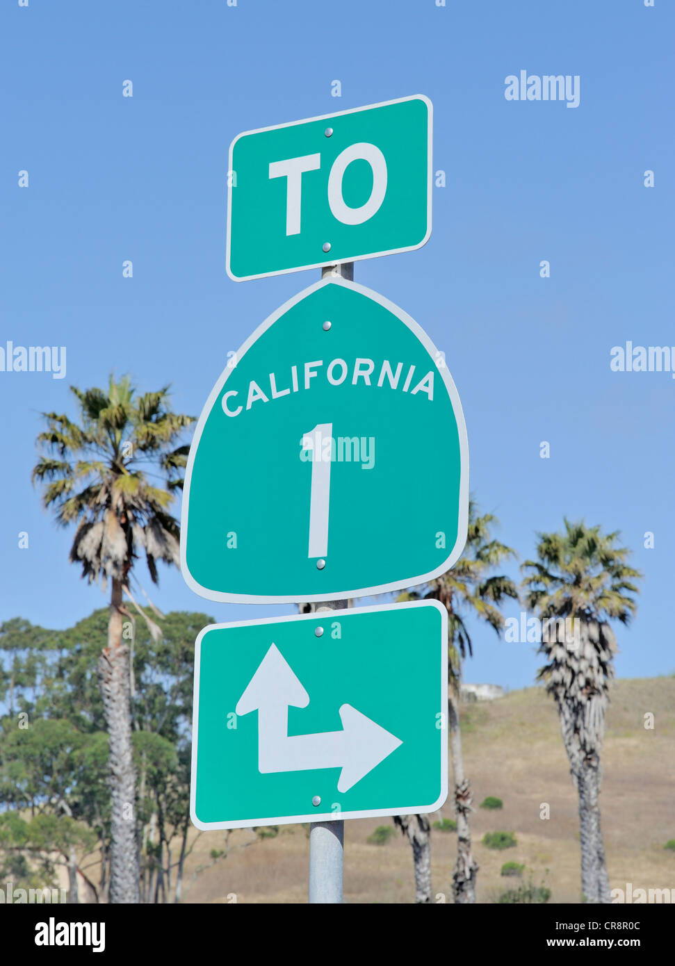 Roadsign on highway one in California, USA with palm trees and sky Stock Photo