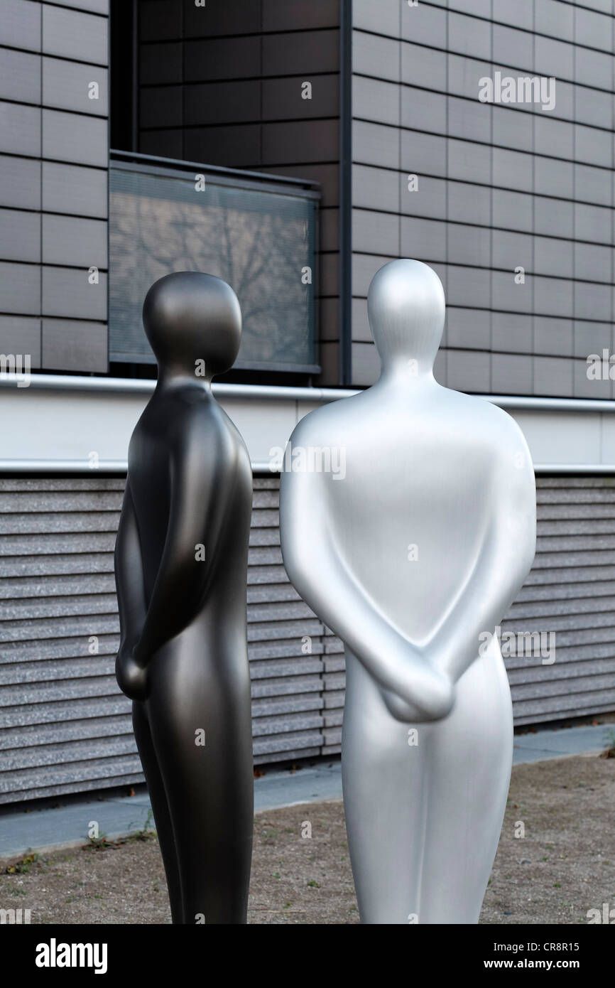 Two manlike sculptures standing side by side, without any individual characteristics, anonymous, modern sculptures Stock Photo