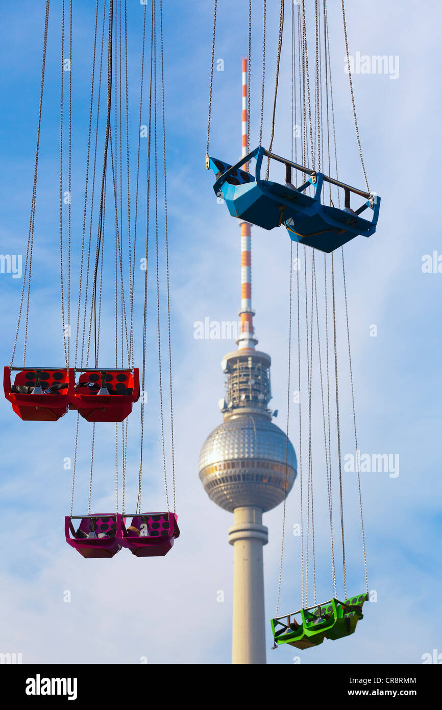 Empty seats of a Chairoplane or swing carousel in front of the Television Tower in Alexanderplatz, Berlin, Germany, Europe Stock Photo