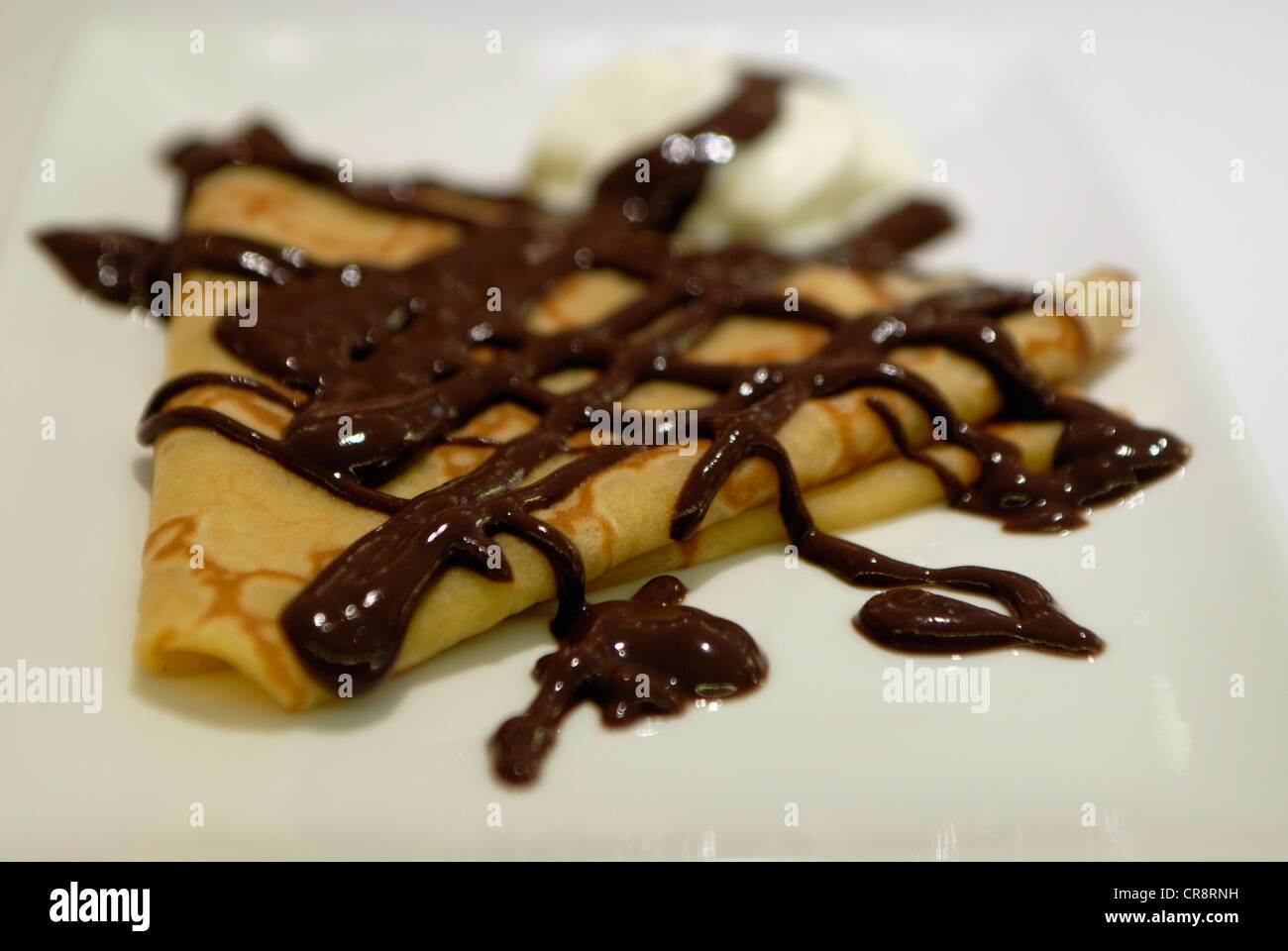 Chocolate and vanilla crepe, decorated with chocolate on top. Bar in