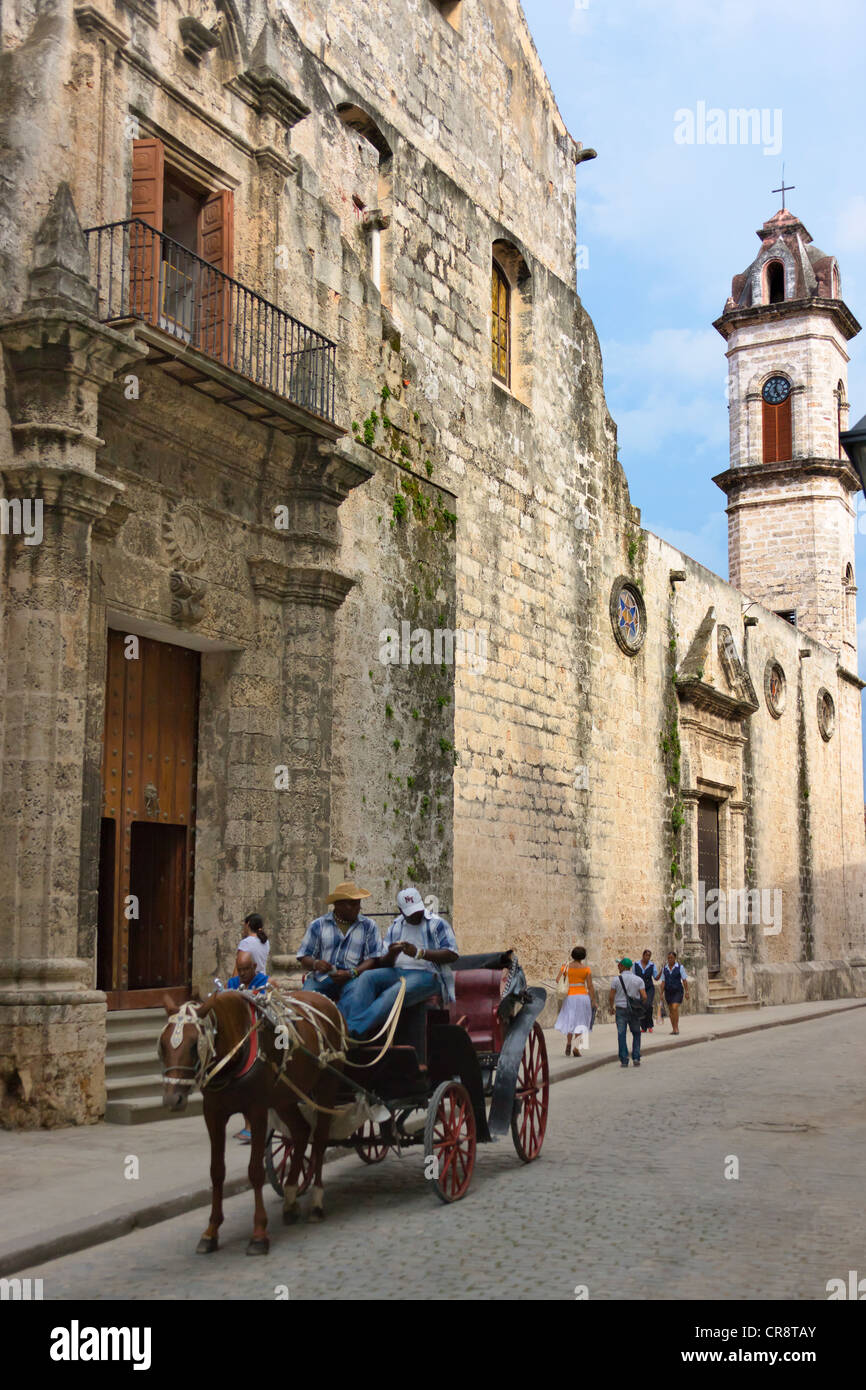 Horse carriage passes by Cathedral of Havana in the historic center, Havana, Cuba Stock Photo