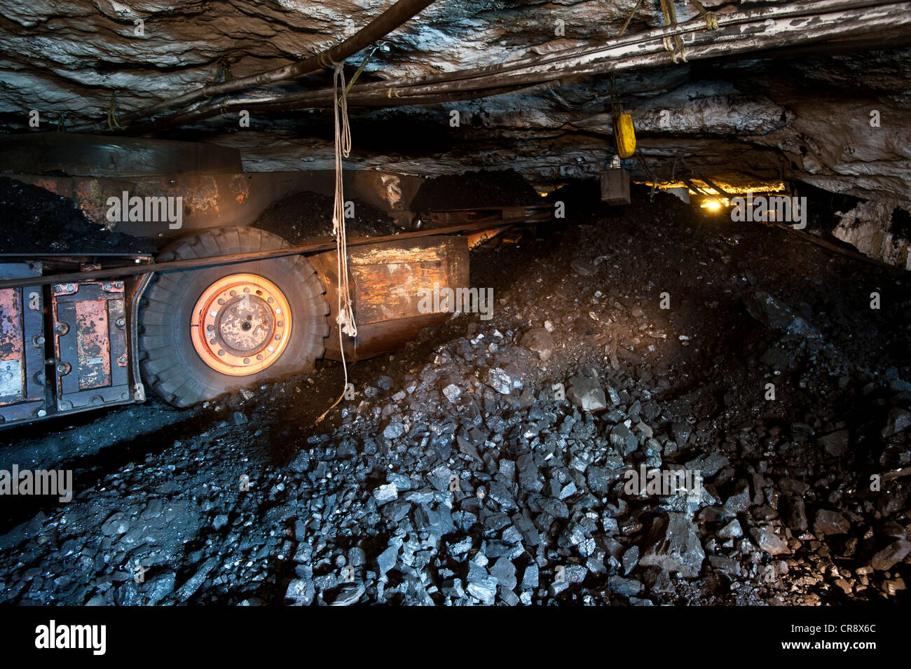 Underground coal mining, transportation of coal to the conveyor belt, Gruve 7, Store Norske Kullkompaniet mine, Longyearbyen Stock Photo