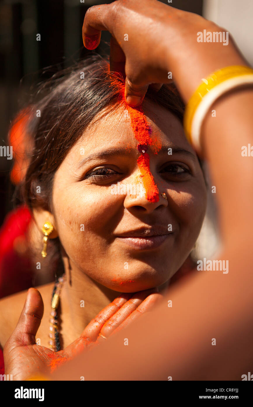 Woman put color(Kumkum) at forehead, Dungeshwari cave(Mahakala caves), Bodh Gaya, Bihar, India Stock Photo
