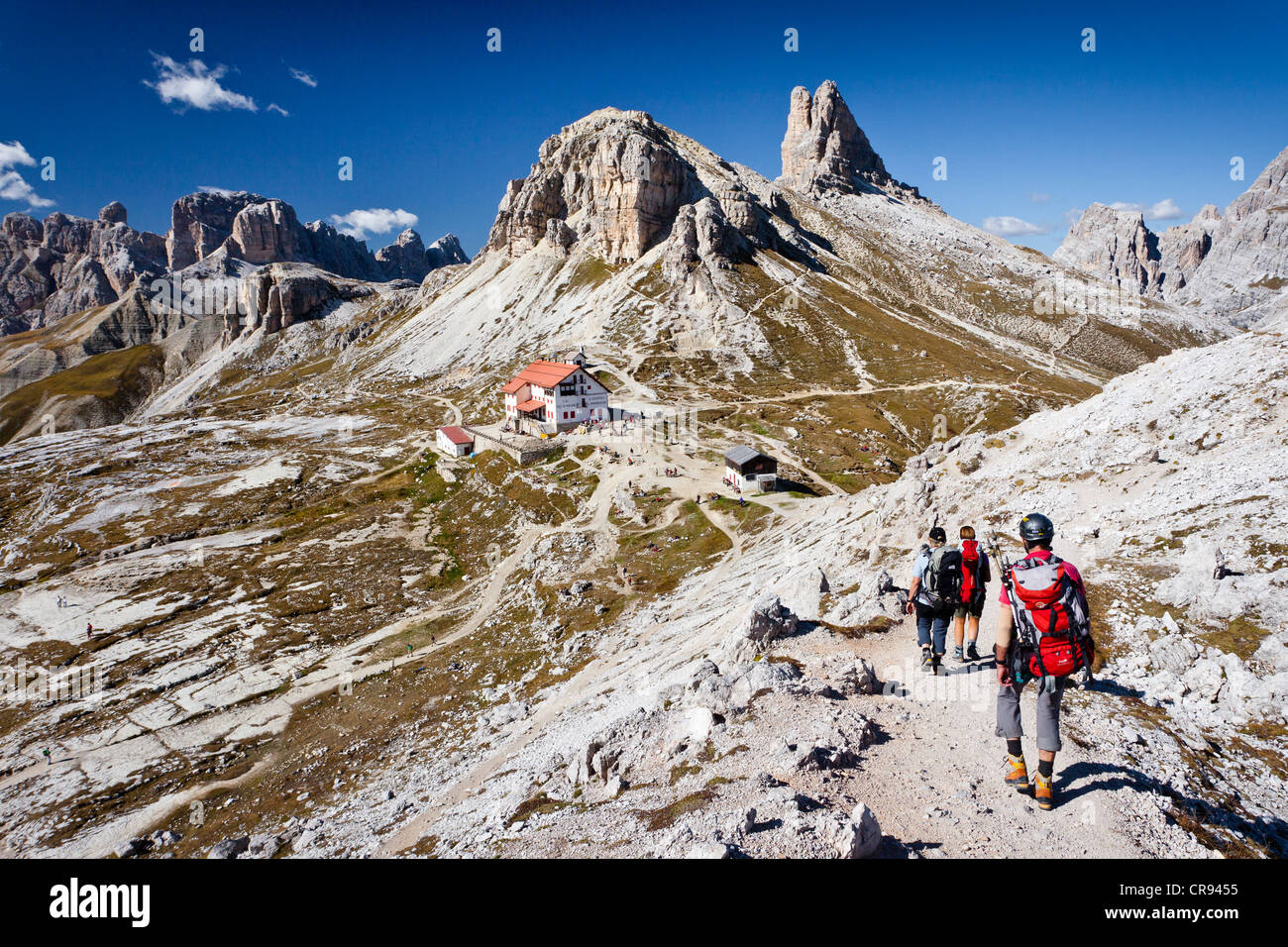 Climber ascending Paternkofel Pass, facing the Three Peaks Hut and the Toblinger Nodes, Sesto, Alta Pusteria, Dolomites Stock Photo