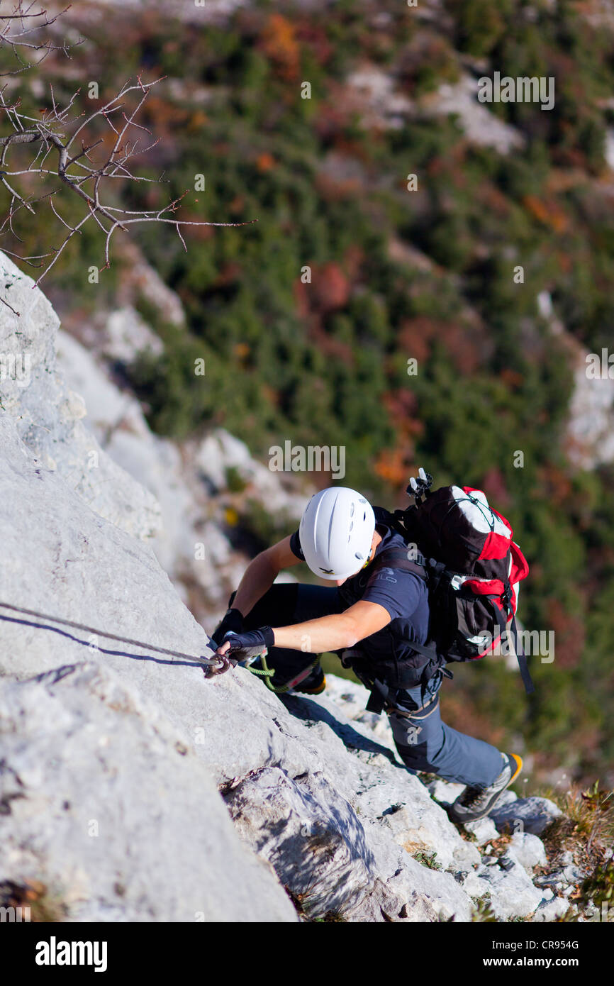 Climber climbing on the Rino Pisetta fixed rope route in the Sarchetal valley above Lake Lago di Toblino, Lake Garda region Stock Photo