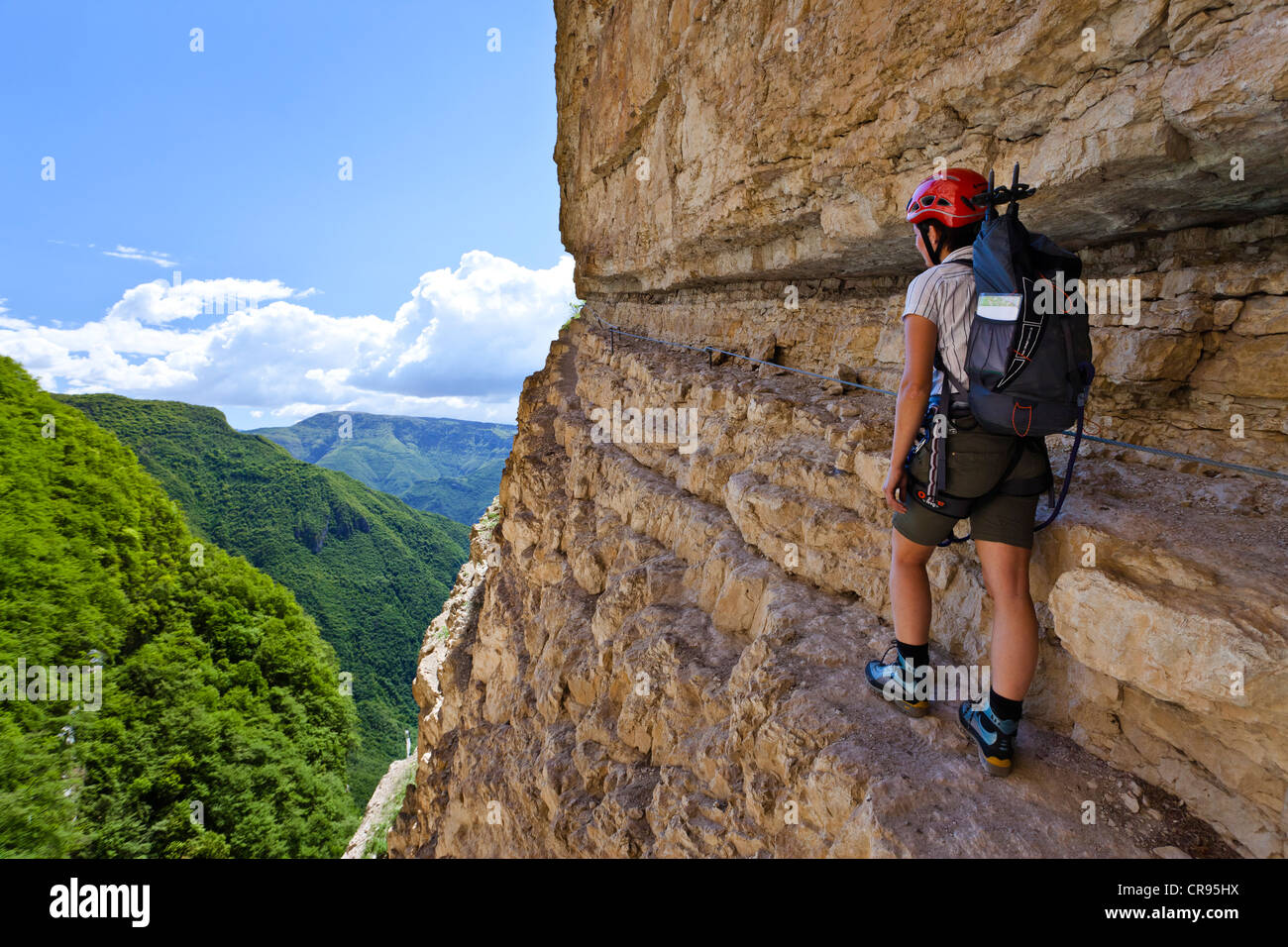 Climber on the Gerardo Sega fixed rope route on Mounte Baldo mountain above Avio, Lake Garda region, province of Trento, Italy Stock Photo