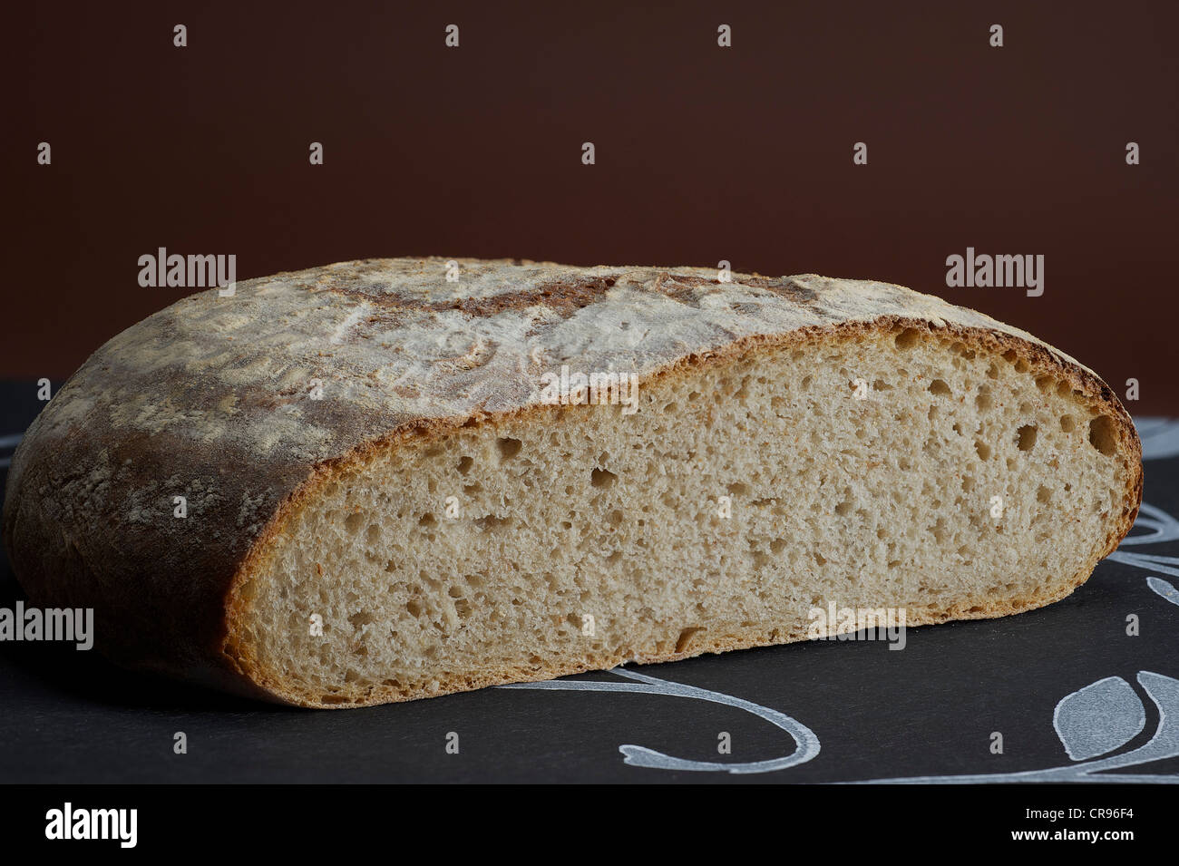 Cut French farm-baked bread Stock Photo