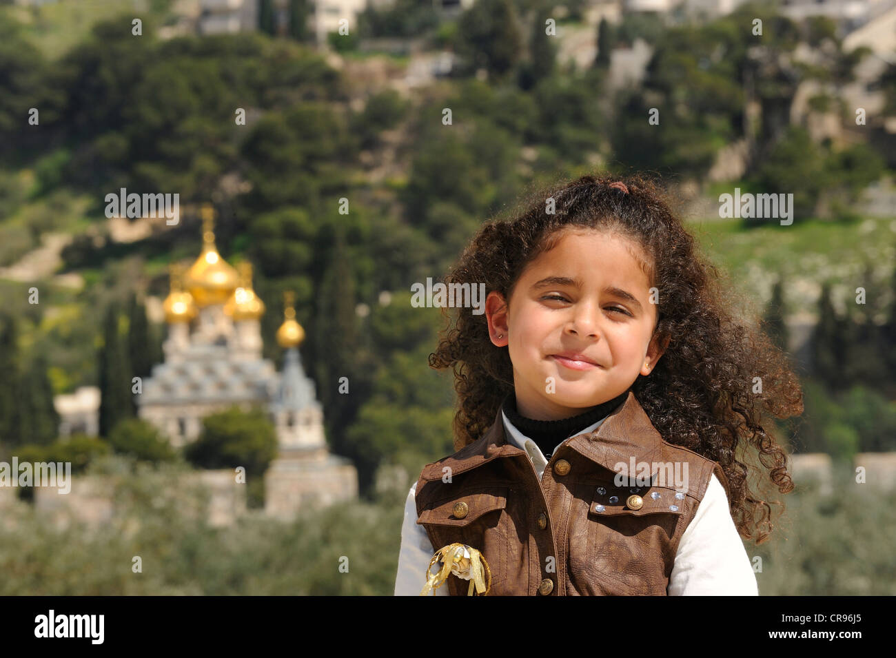 Religious diversity, Israeli-Palestinian girl on the Temple Mount, Russian Orthodox Church of Mary Magdalene on the Mount of Stock Photo