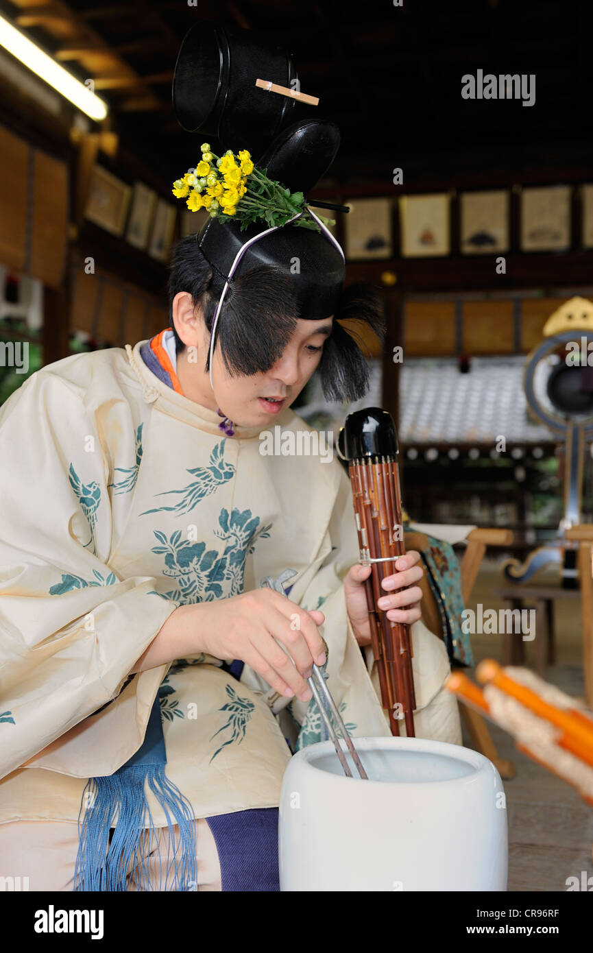 Sho, a mouth organ, being warmed above a charcoal basin, Imamiya Shrine, Autumn Festival of Jidai-Matsuri, Kyoto, Japan, Asia Stock Photo