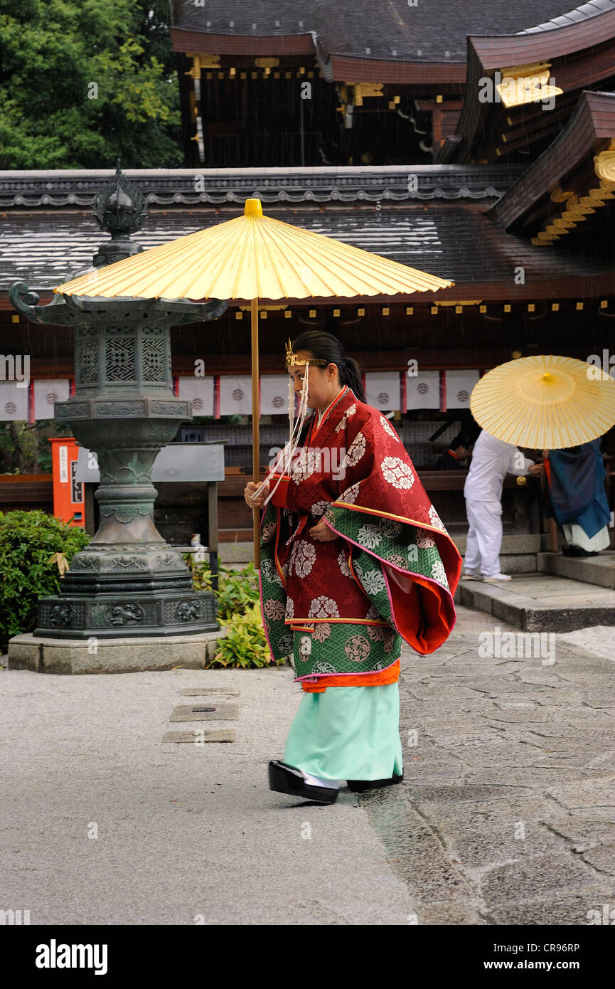 Miko, a female shaman, carrying an oil paper umbrella during a ceremony,  Imamiya Shrine, Autumn Festival of Jidai-Matsuri, Kyoto Stock Photo - Alamy