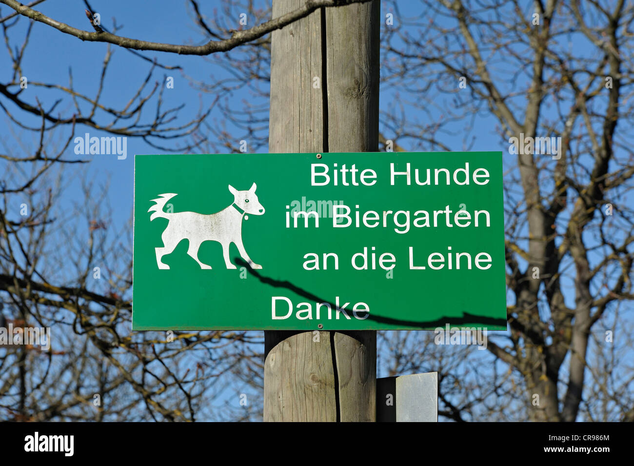 Sign 'Bitte Hunde im Biergarten an die Leine', German for 'please keep dogs on a leash in the beer garden', MichaeliGarten in Stock Photo