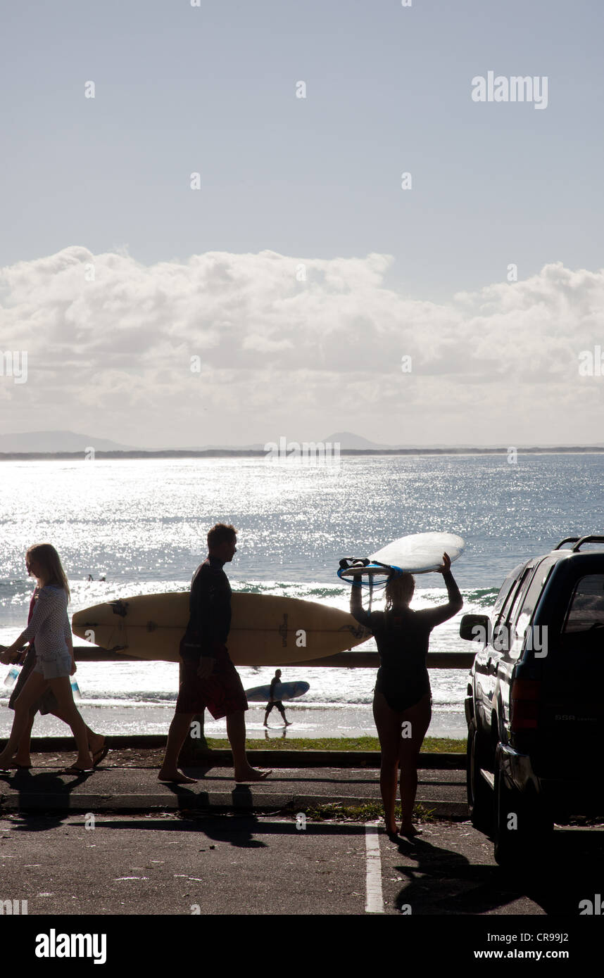Man and woman carrying surfboards at beach, horizon in distant, Sunshine Coast, Brisbane