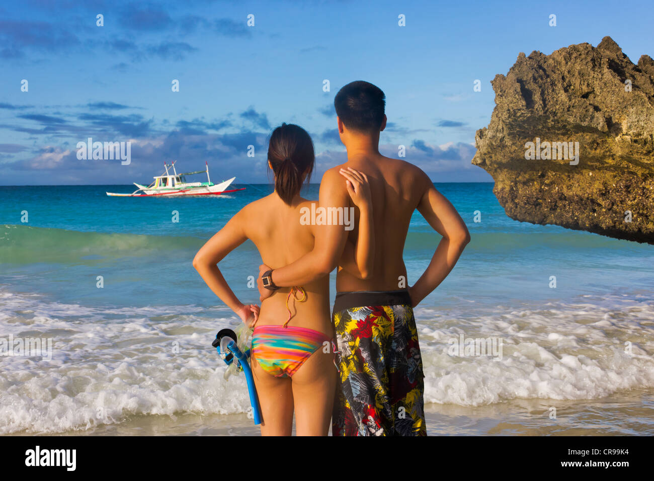 Young tourist couple with snorkeling equipment on the beach, Boracay Island, Aklan Province, Philippines Stock Photo