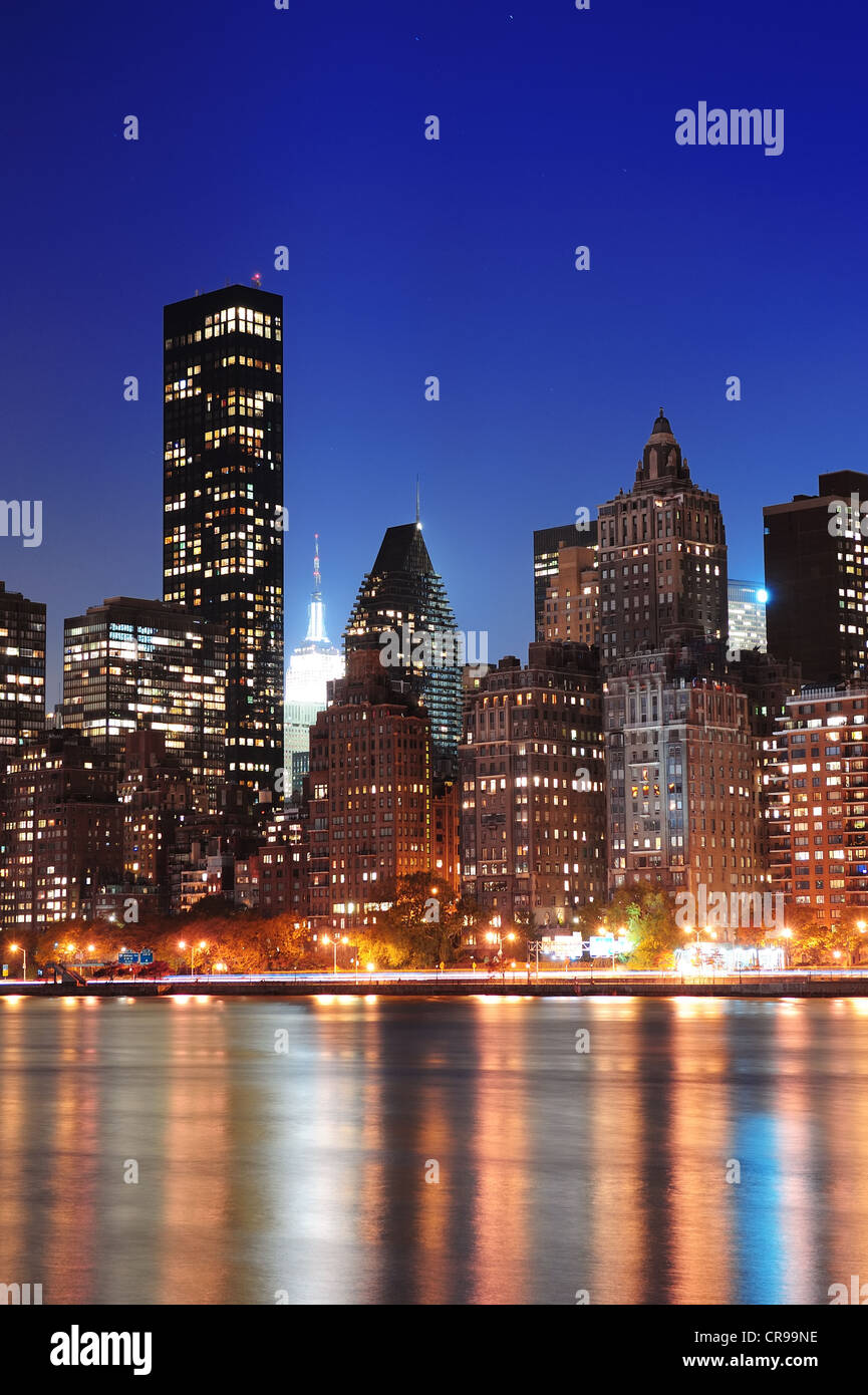 New York City Manhattan midtown skyline at night over East River Stock ...