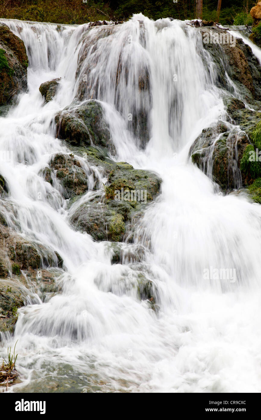 Waterfall, water flows down, over rocks. Little creek, river. Stock Photo
