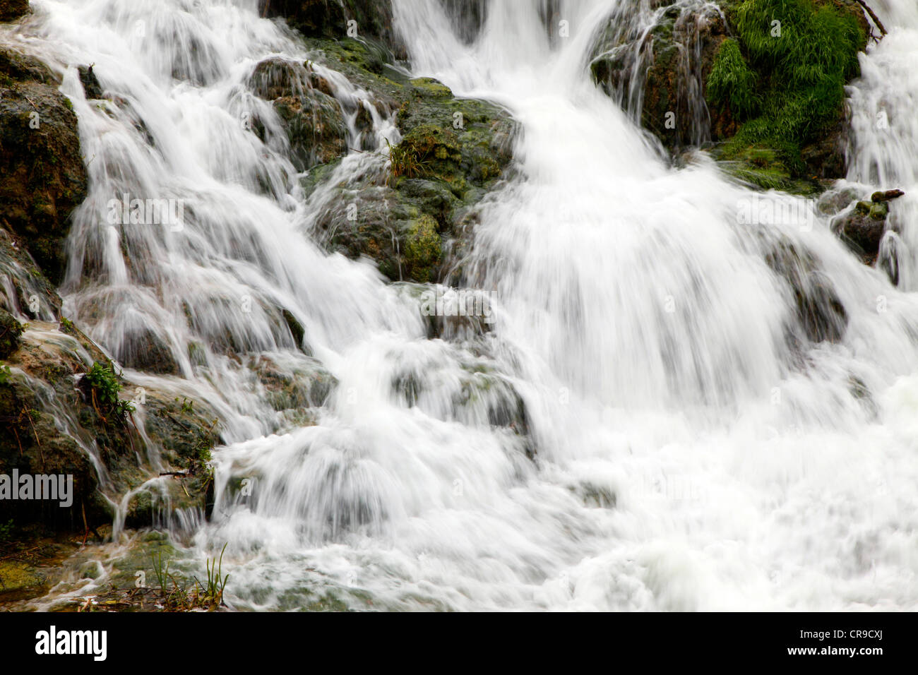 Waterfall, water flows down, over rocks. Little creek, river. Stock Photo