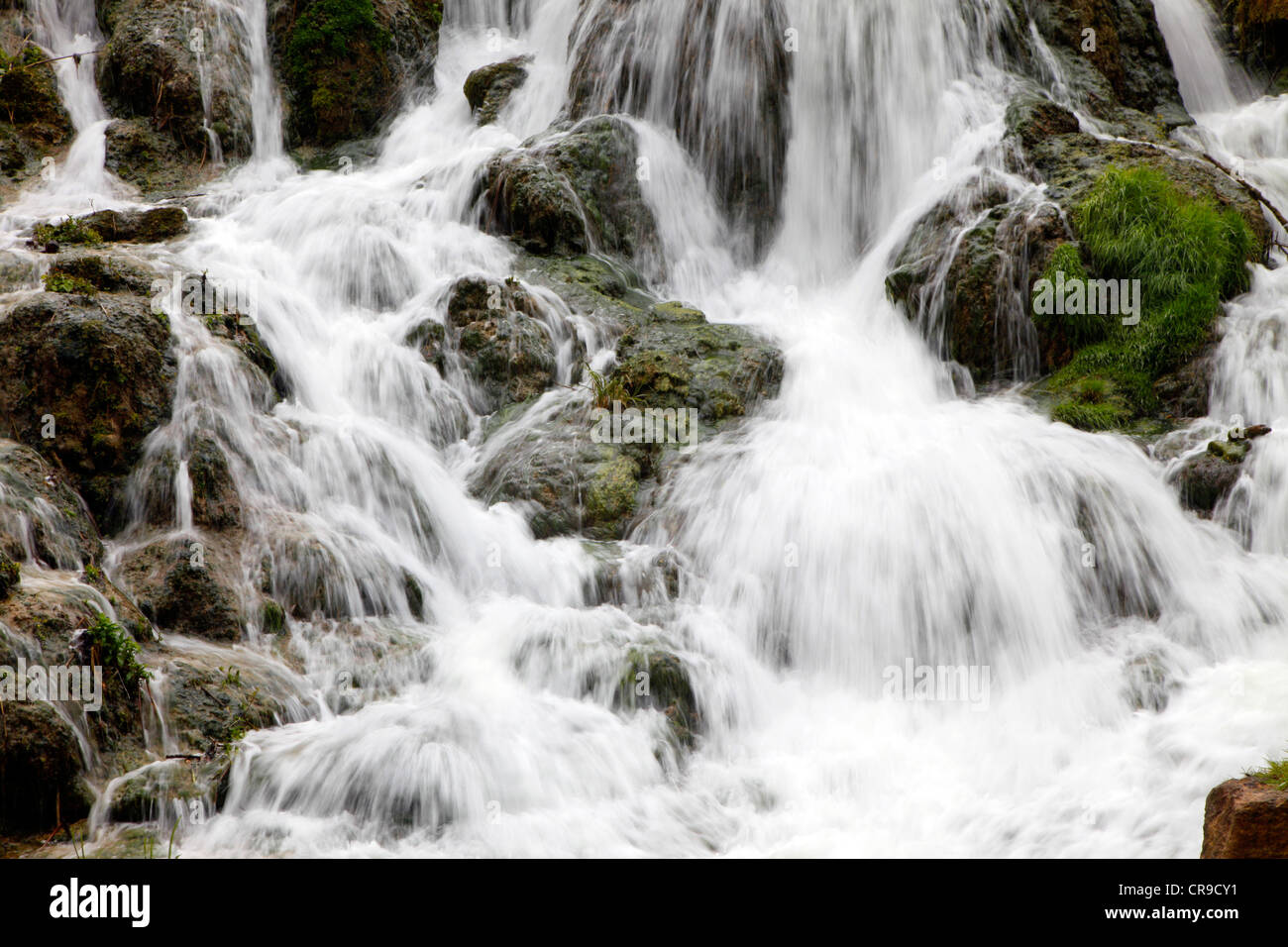 Waterfall, water flows down, over rocks. Little creek, river. Stock Photo