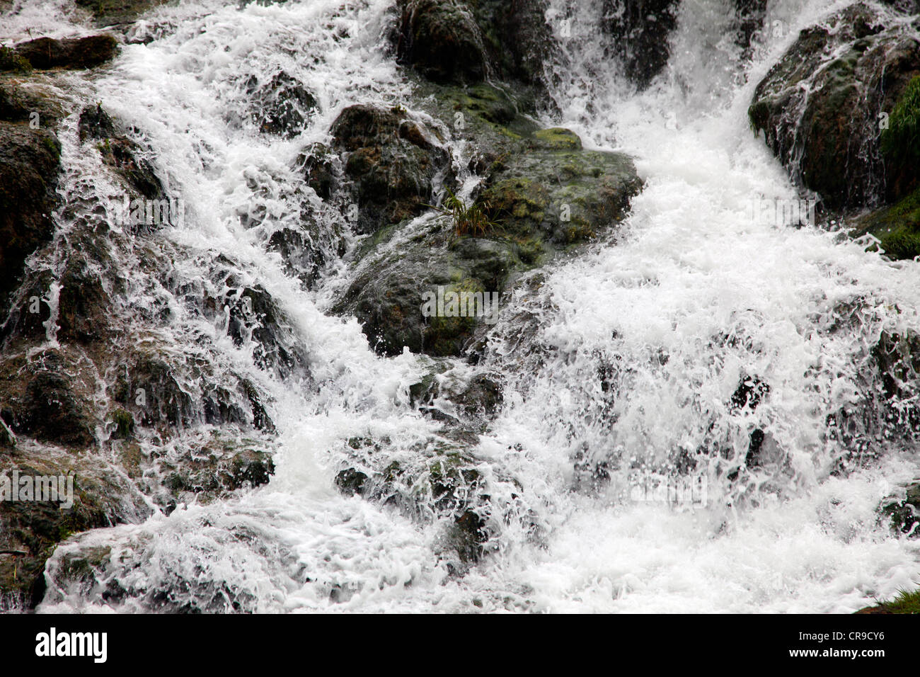 Waterfall, water flows down, over rocks. Little creek, river. Stock Photo