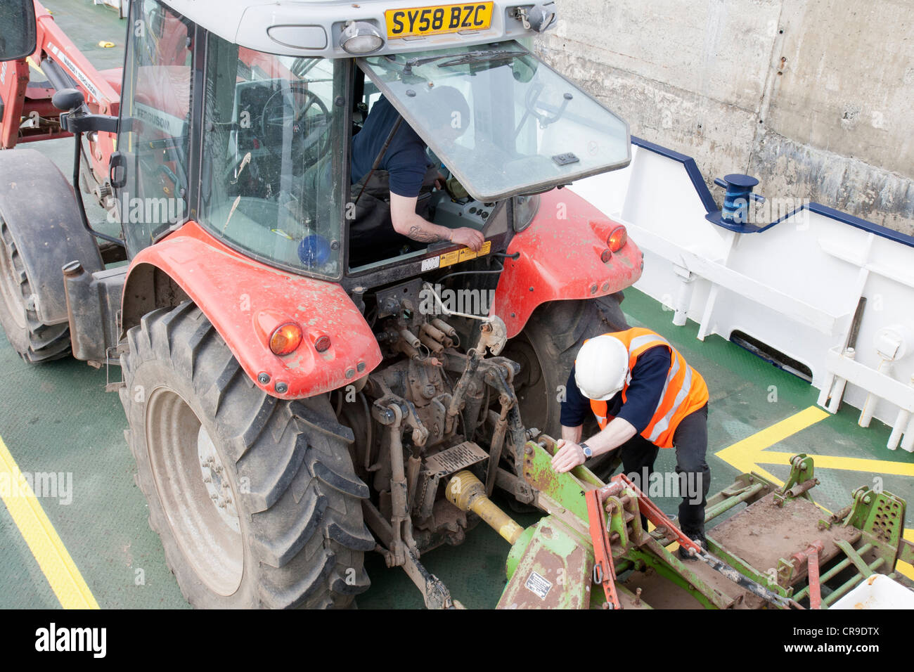 The Island of Rousay securing a tractor on the ferry - Orkney Islands, Scotland Stock Photo