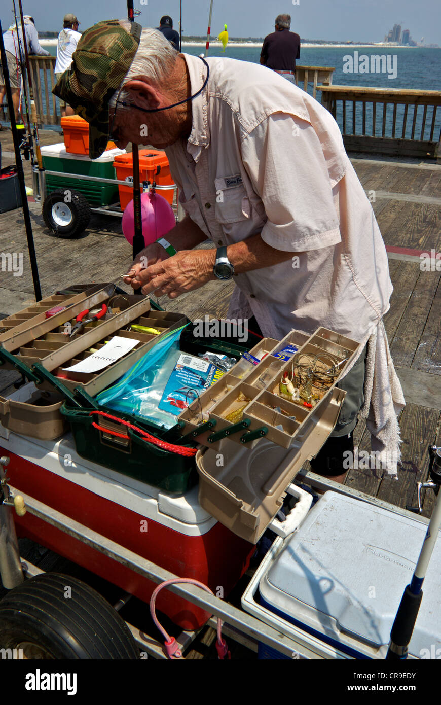 Male angler hooks fishing gear tackle box cooler cart Gulf Shores Alabama  State Park saltwater angling pier Stock Photo - Alamy