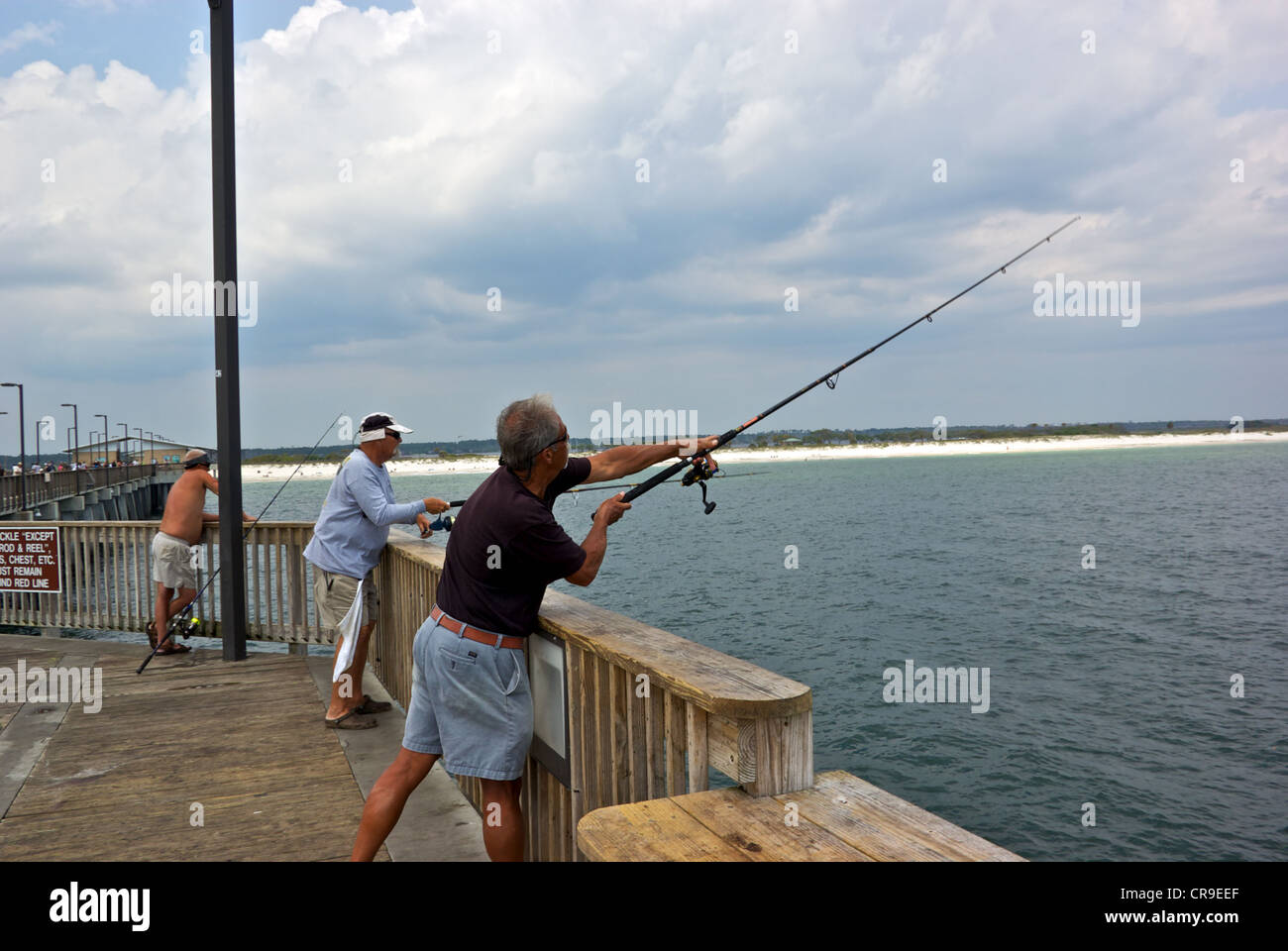Male angler casting spinning rod reel Gulf Shores Alabama State