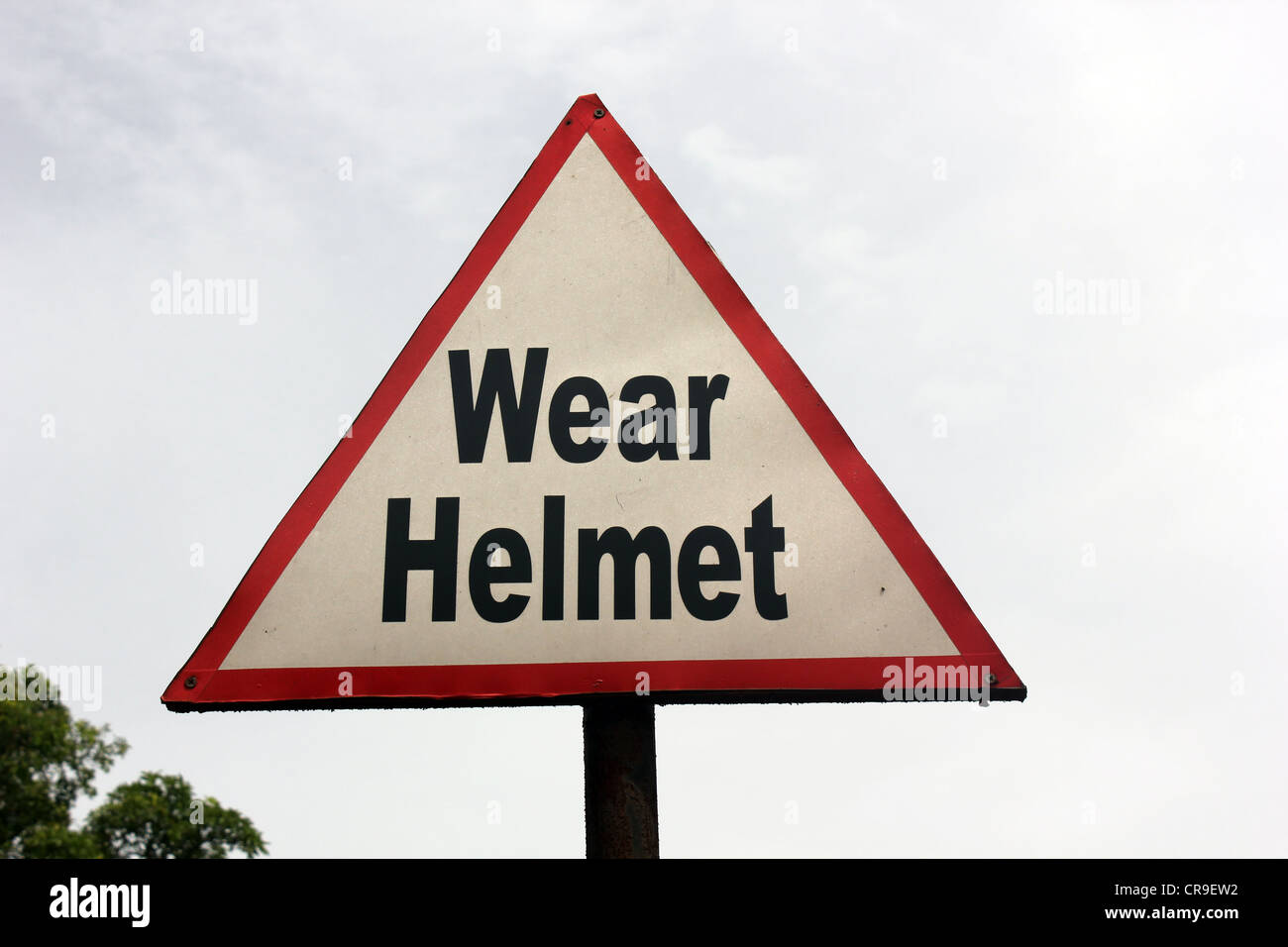 A sign board stating the bikers to wear helmet Stock Photo - Alamy
