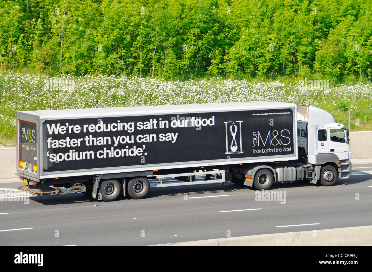 M&S delivery lorry and trailer with slogan promoting salt reduction in food Stock Photo