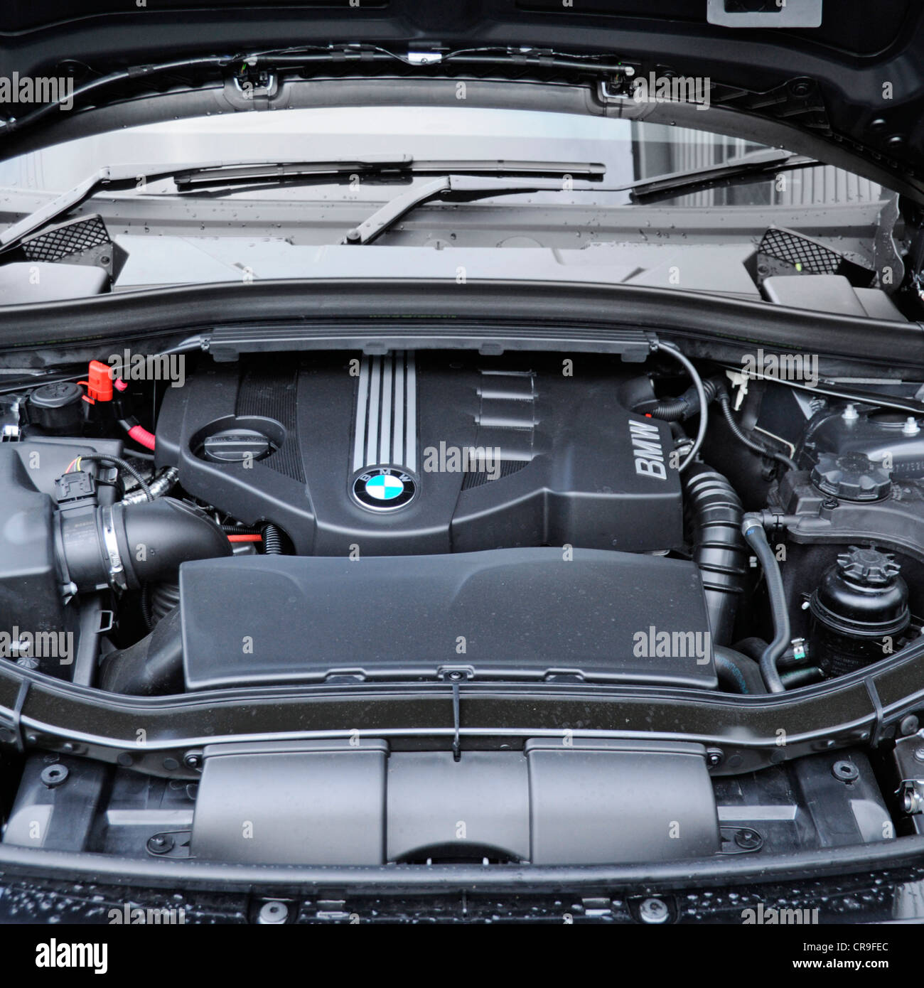 Engine compartment & components under the bonnet of a BMW X1 Sdrive 18d diesel car England UK Stock Photo