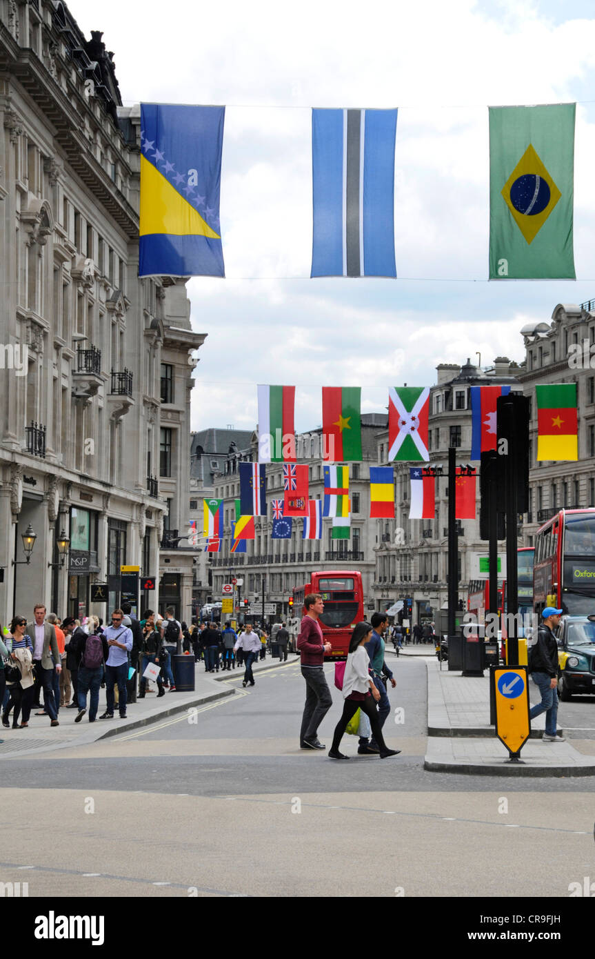 London street scene selection of national flags from 206 countries competing in London 2012 Olympics displayed above Regent Street shopping area Stock Photo