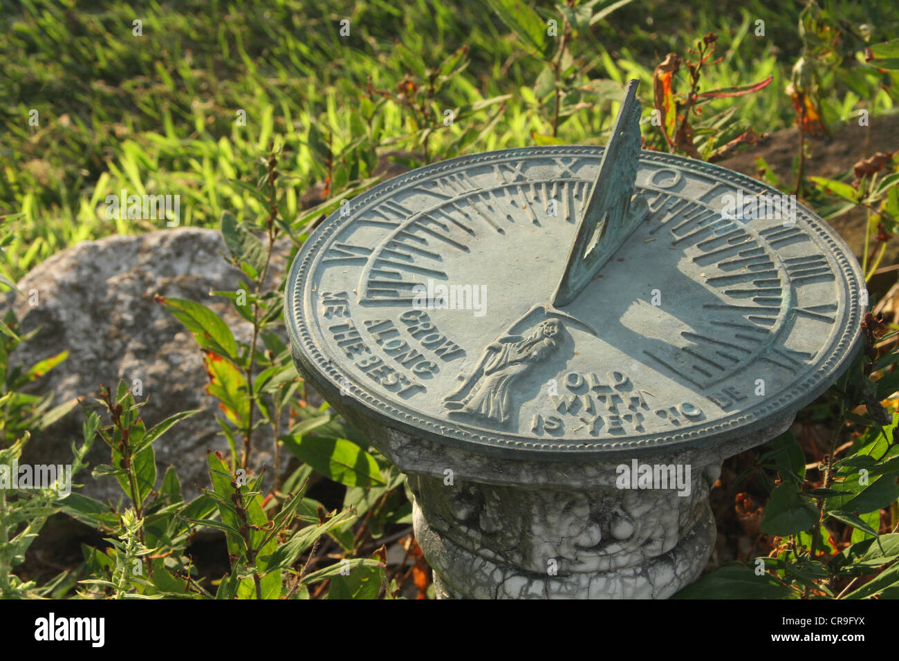 Sun Dial in a Garden. Scene from a back yard water garden in Beavercreek, Dayton, Ohio, USA. Stock Photo