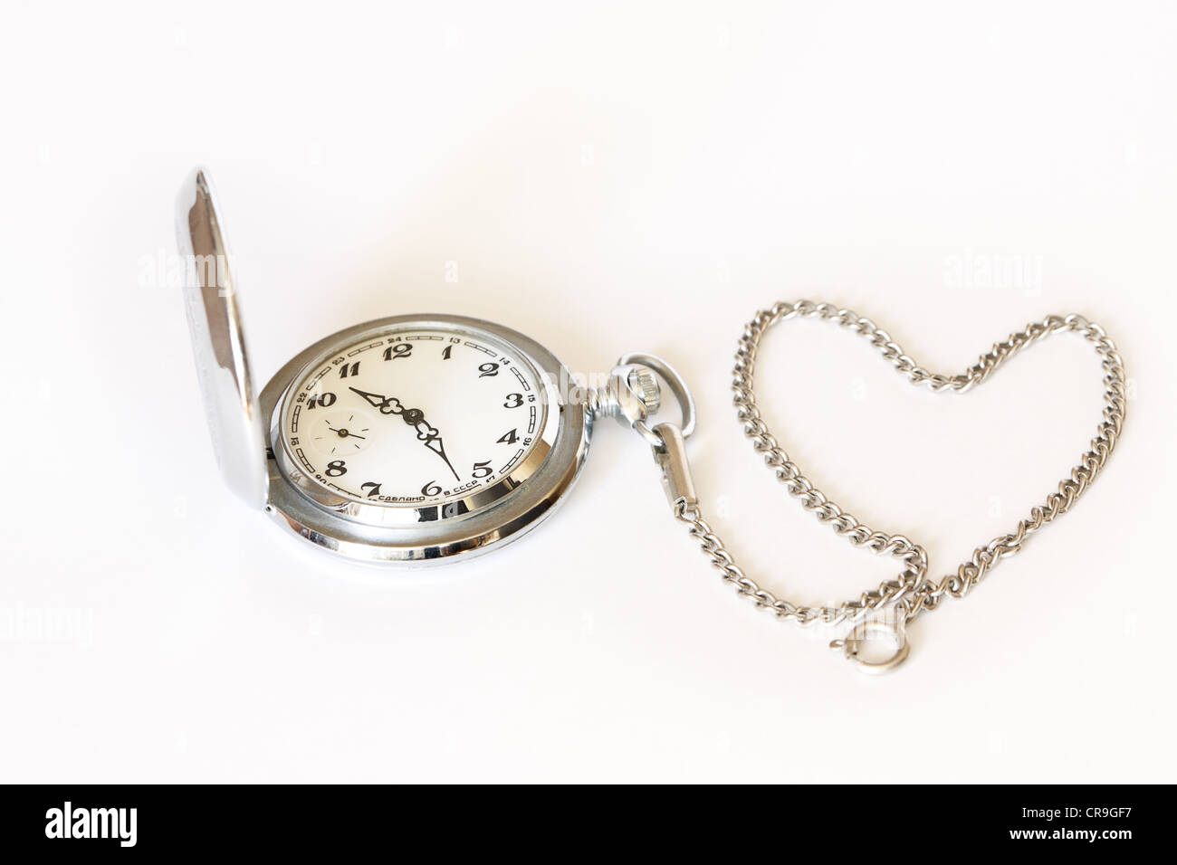 Pocket watch with chain in the form of a heard on white background Stock Photo