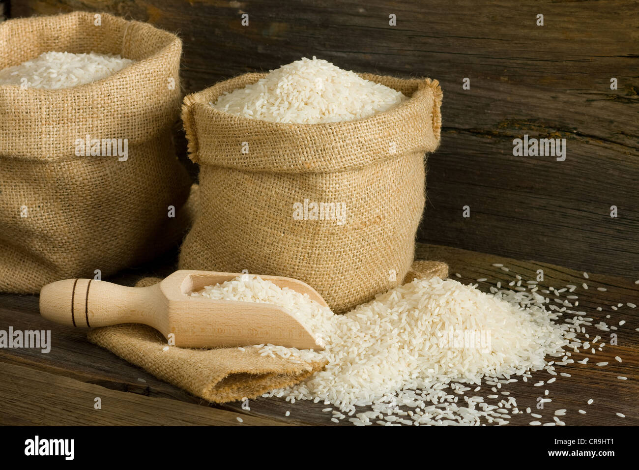 White uncooked rice in burlap bag Stock Photo