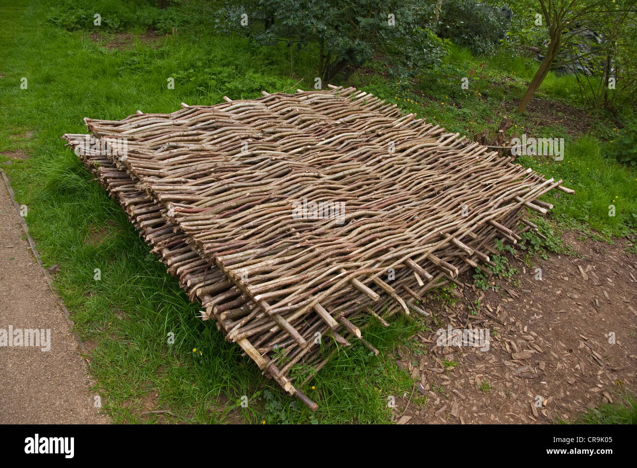 Woven willow hurdles stacked on ground, ready for use Stock Photo Alamy