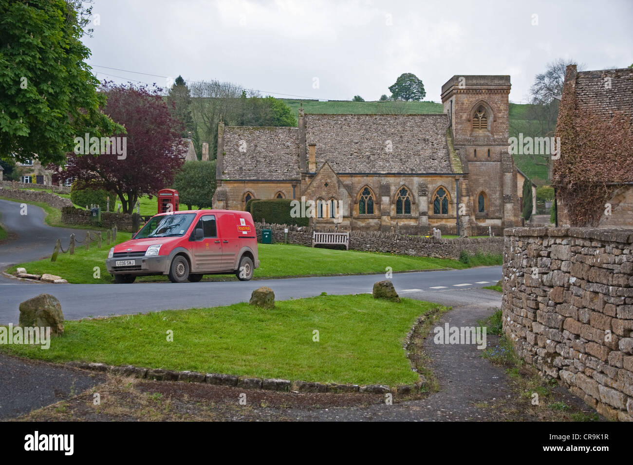 St Barnabas Church, Snowshill, Worcestershire, with red post van in foreground Stock Photo