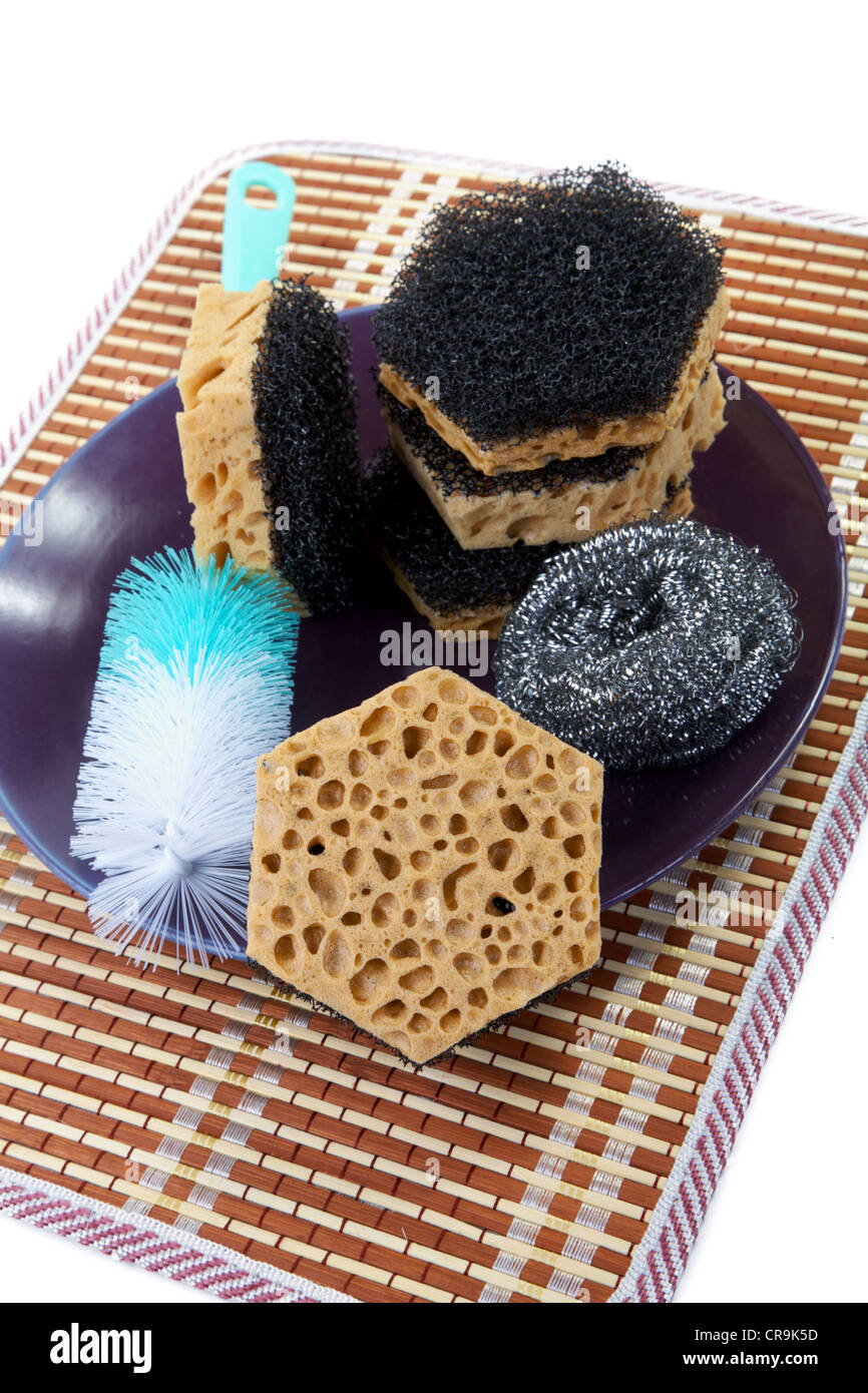 Still-life with sponges for washing of ware and a plate Stock Photo