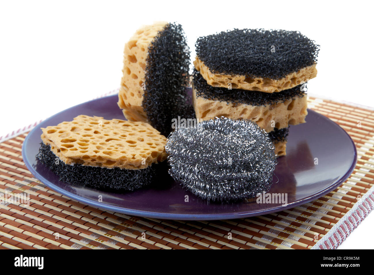 Still-life with sponges for washing of ware and a plate Stock Photo