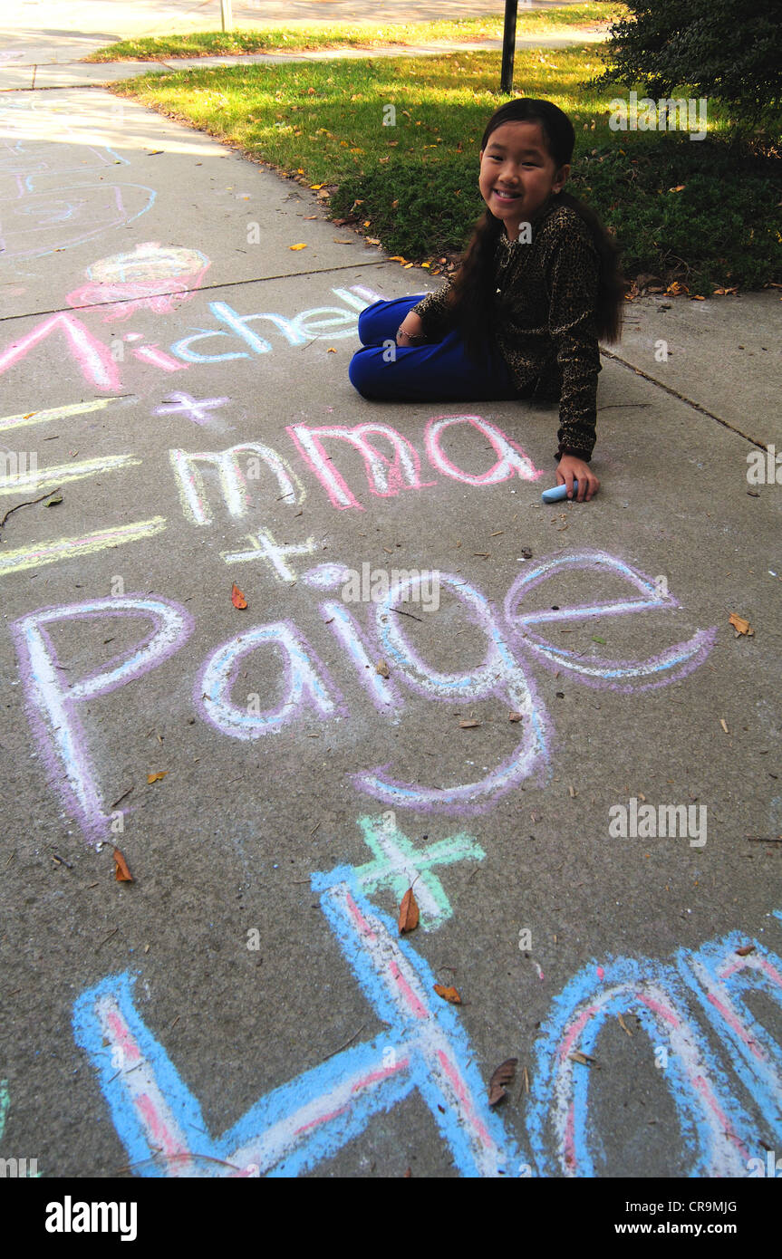 Young Asian girl using drawing with sidewalk chalk Stock Photo - Alamy