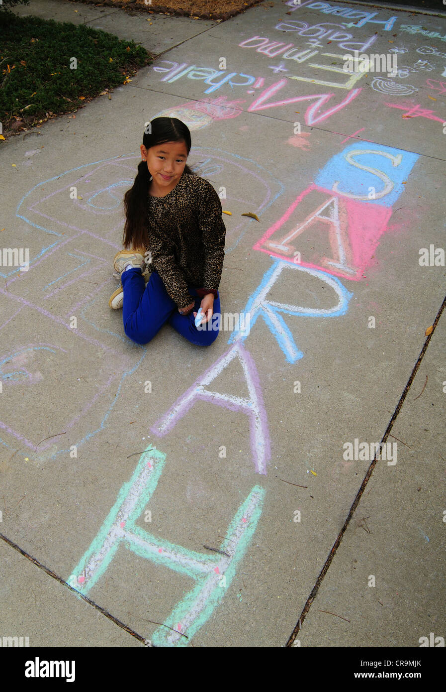 Young Asian girl using drawing with sidewalk chalk Stock Photo - Alamy