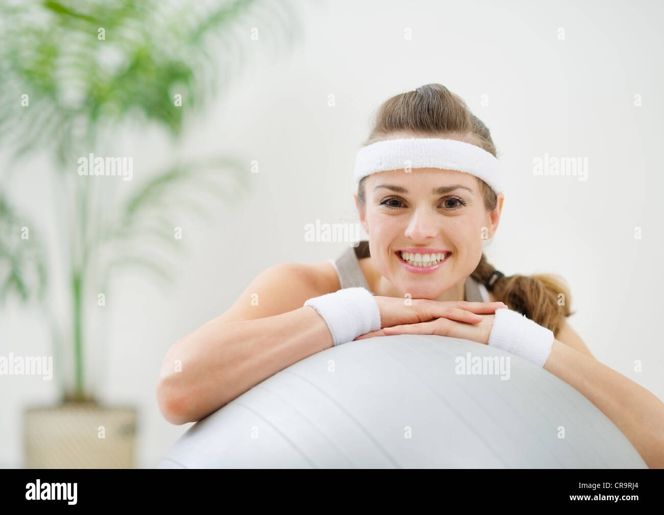 Portrait of smiling healthy woman on fitness ball Stock Photo - Alamy