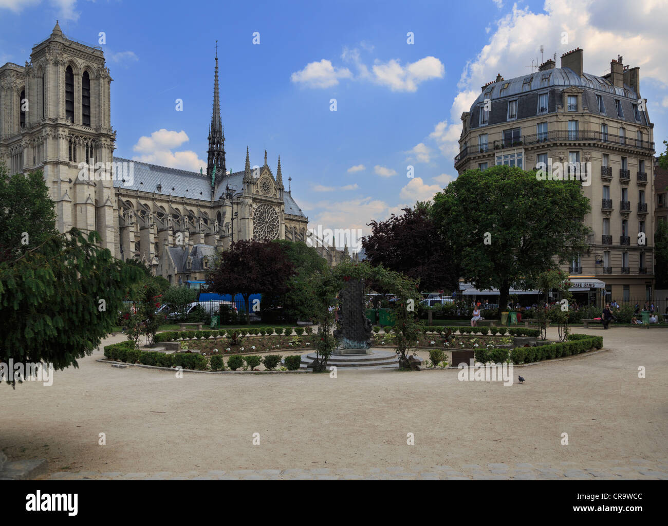 Square Rene Viviani, Paris. The Fontaine Saint Julien Le Pauvre is a modern contrast to the Cathedral of Notre Dame behind. Stock Photo