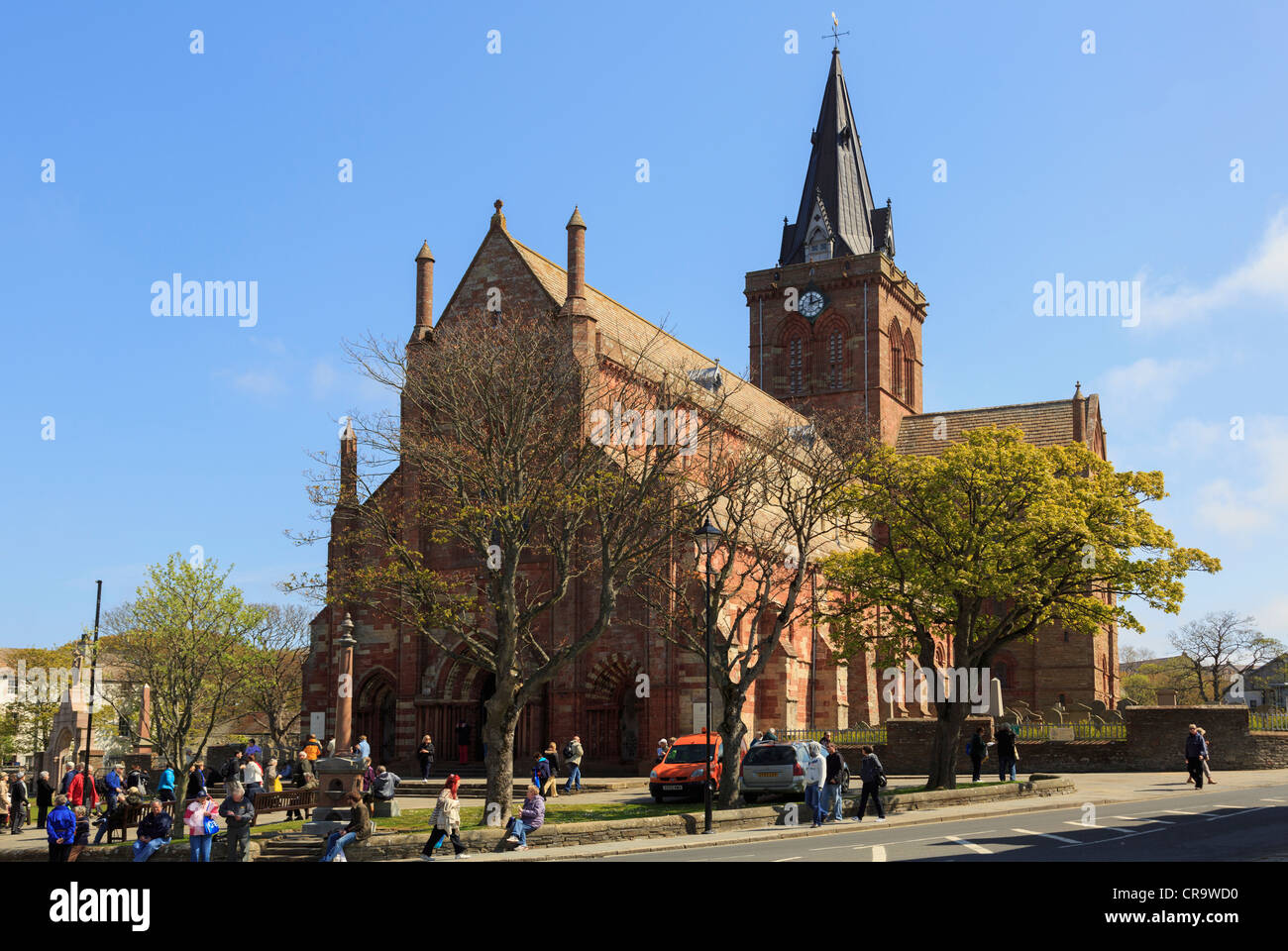 Street scene at Kirk Green with trees growing outside St Magnus cathedral busy with tourists Kirkwall Orkney Mainland Scotland Stock Photo